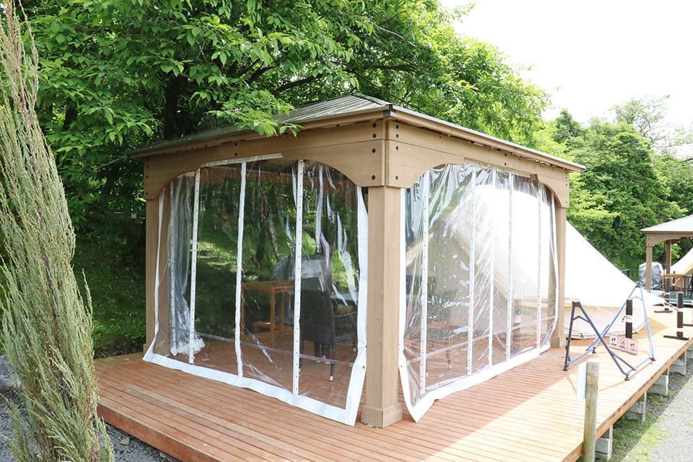 A gazebo with clear curtains for peace of mind on rainy days